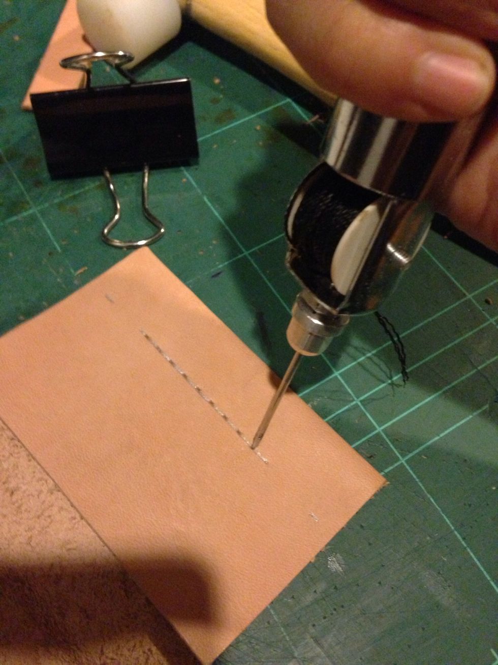 Using an awl punch a hole for the stitching