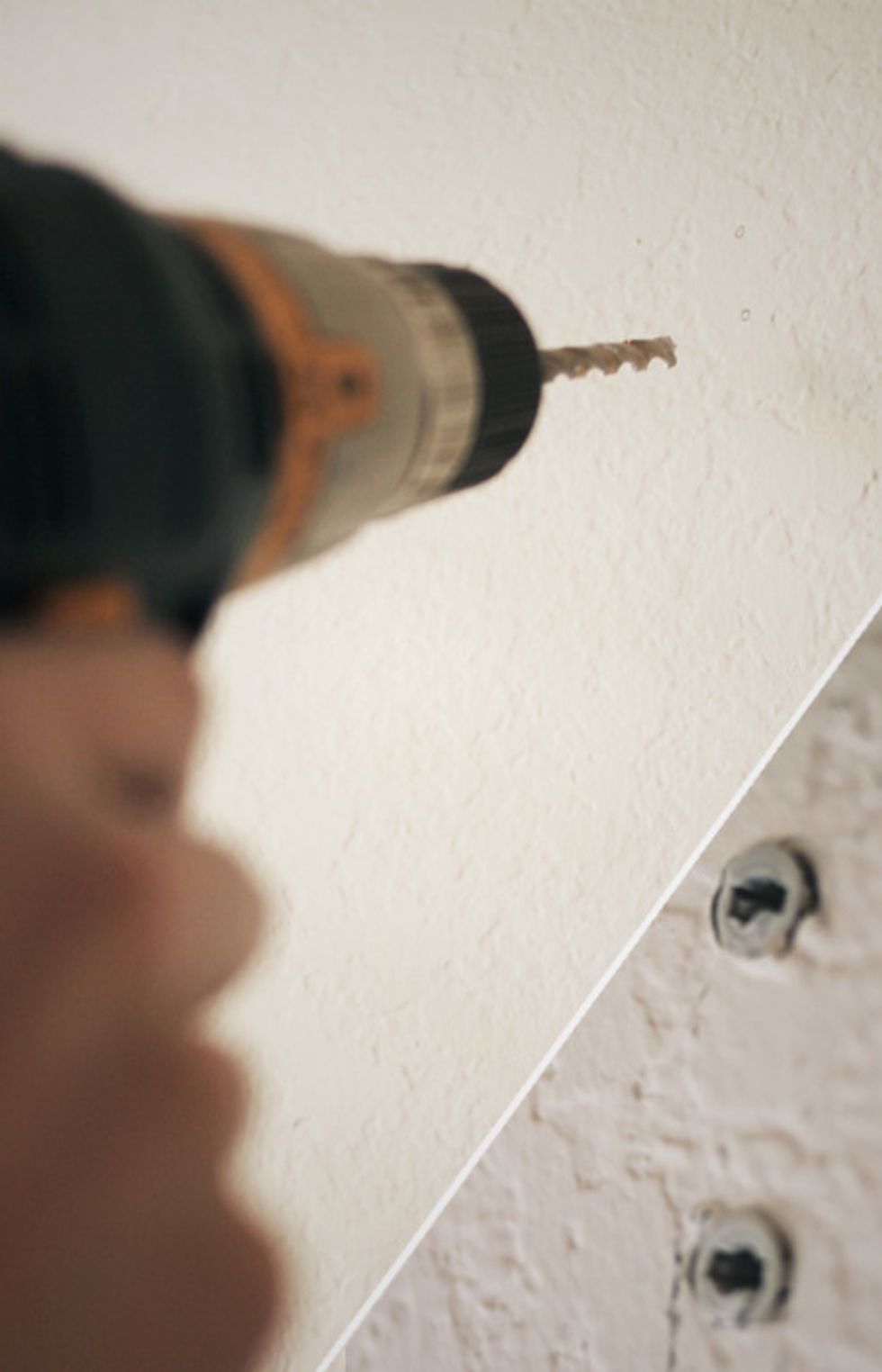 Using an electric drill and the size drill bit specified on your drywall anchor packaging, drill holes as marked. Insert the drywall anchors using a hammer if necessary.