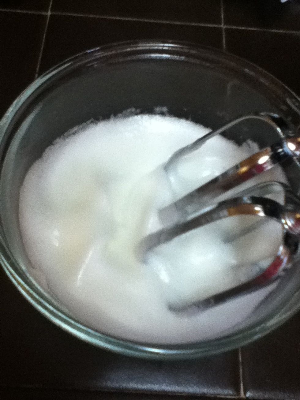 Using an electric mixer, beat the whites until stif peaks form.