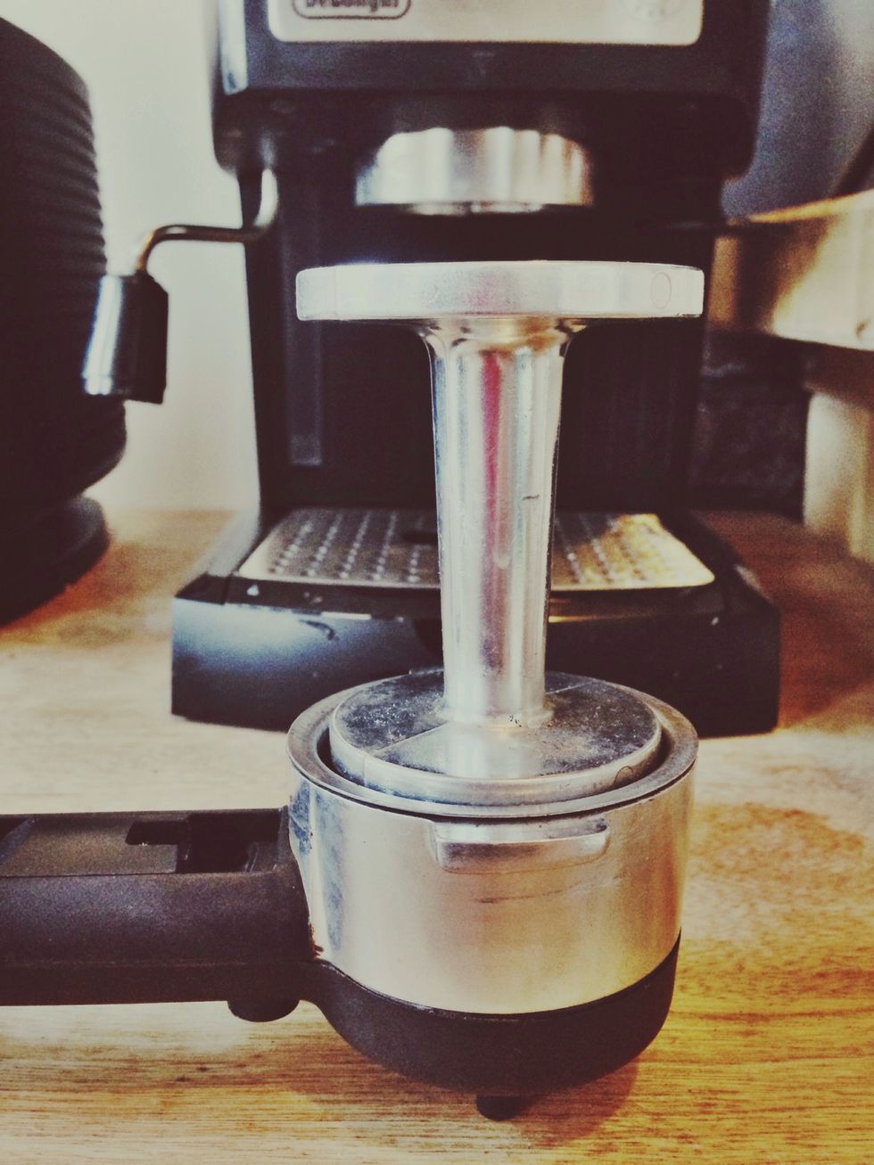 Using an espresso tamper, press grounds into the basket of the portafilter. Twist the portafilter into the grouphead. The grouphead will pull heated water from reservoir and filter through grounds.
