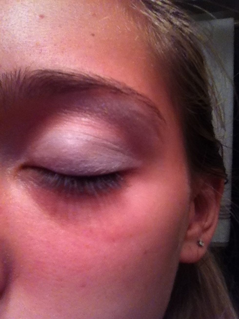 Using an eyeshadow brush apply the light blue (or) green shadow all over your lid leaving the crease of your eye still uncovered.