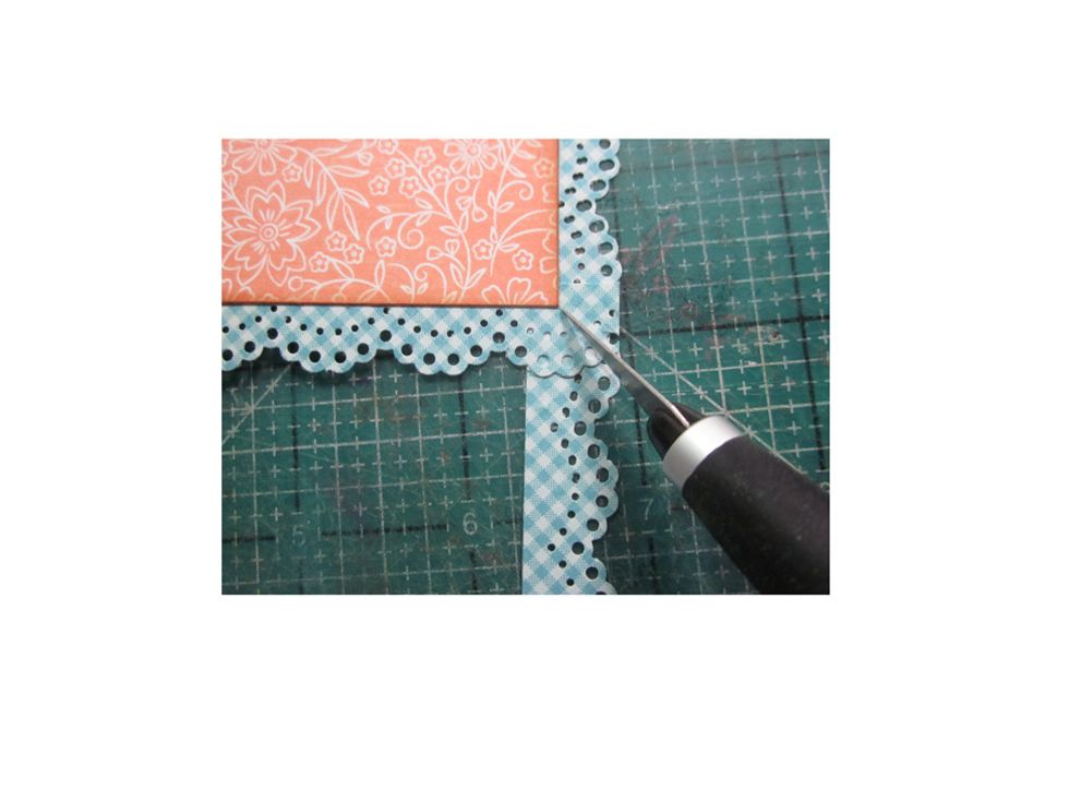 Using an X-acto tool , cut outward from the corner and remove the excess paper.
