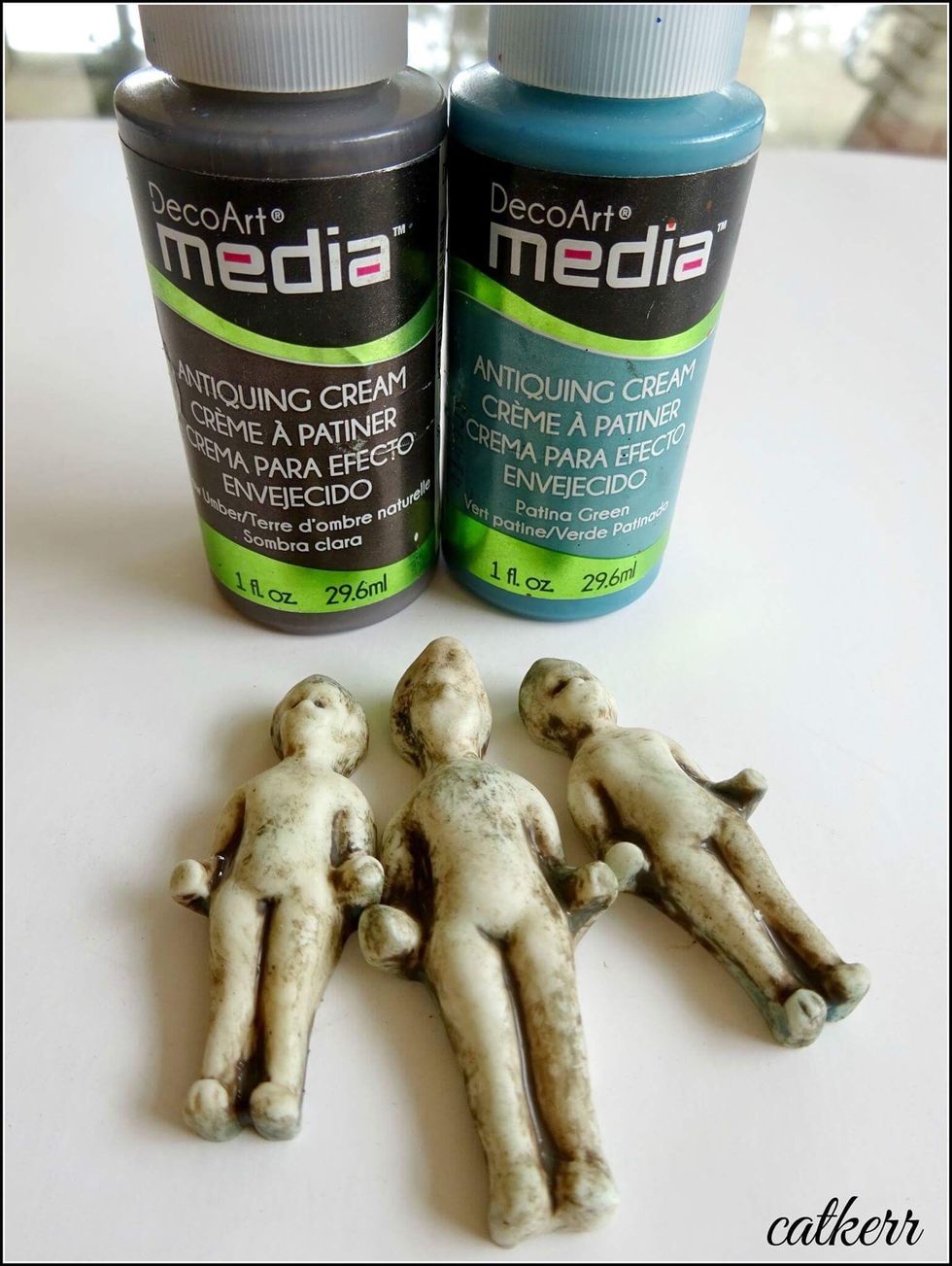 Using Antique Cream on the relics and rub it off with a paper towel. Add Rub on words to the body. Spray in gold Metallic Lustre.