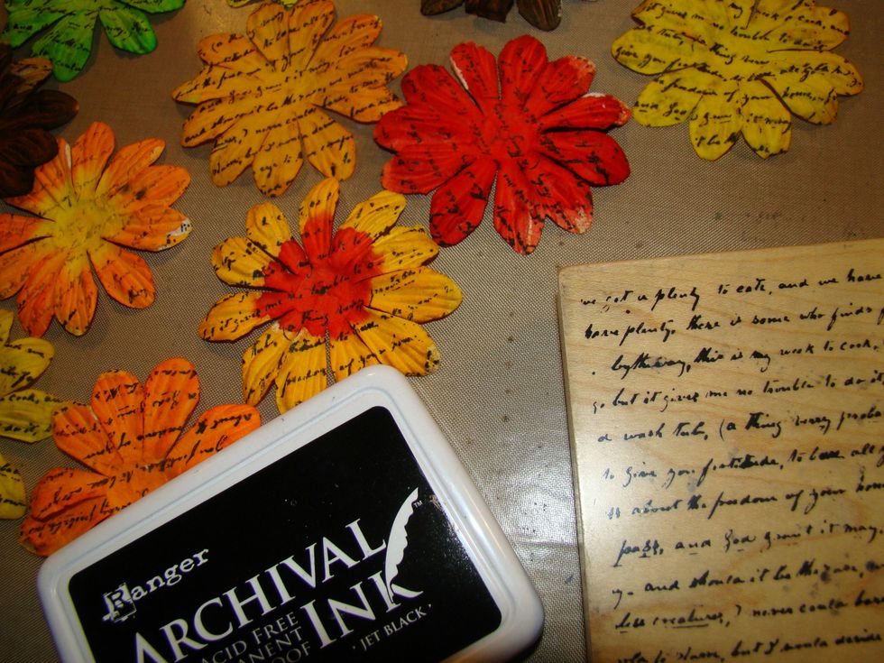 Using Archival Ink, stamp script across all the flowers and on the back side.