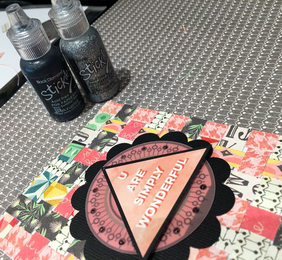 Using Black Diamond Stickles, embellish the tiny circles on the vellum die cut to add some sparkle. Use the Silver Stickles to outline the black scallop circle.