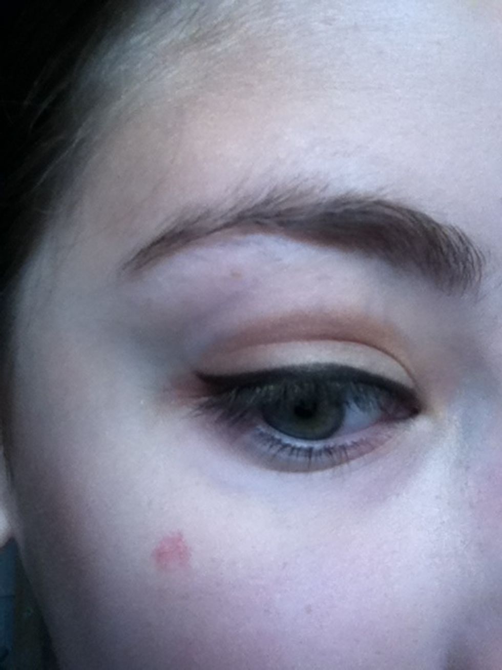 Using black eyeshadow line your upper lid and slightly wing it out.