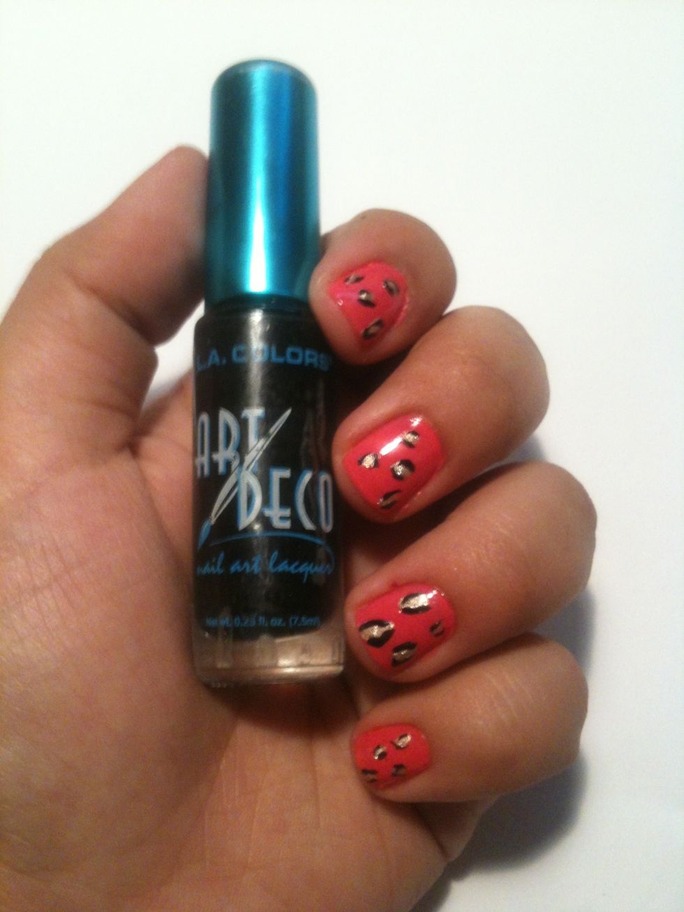 Using black nail polish and a fine tipped brush add two detached Cs around the gold spots. You can also fill in the pink gaps with random spots and Cs..