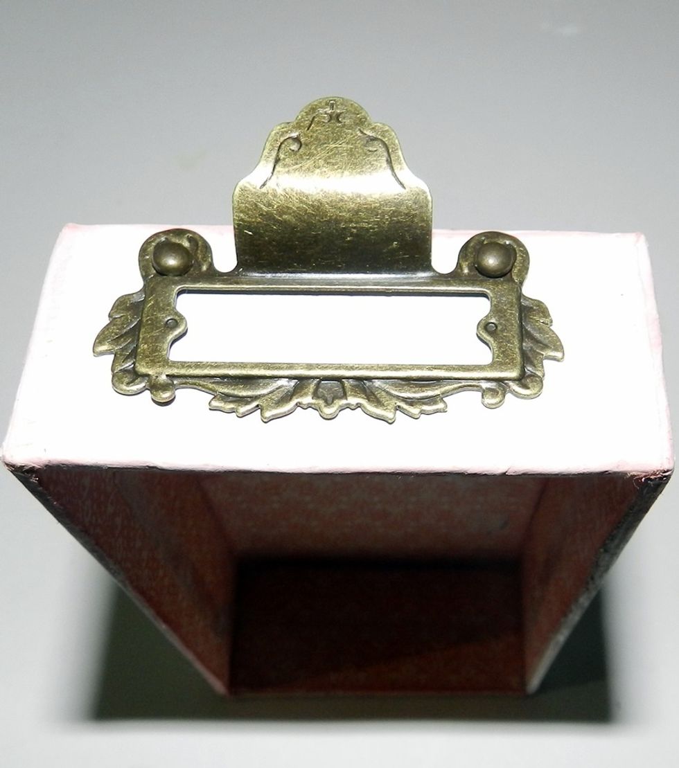 Using brads, attach G45 metal on top of the box.