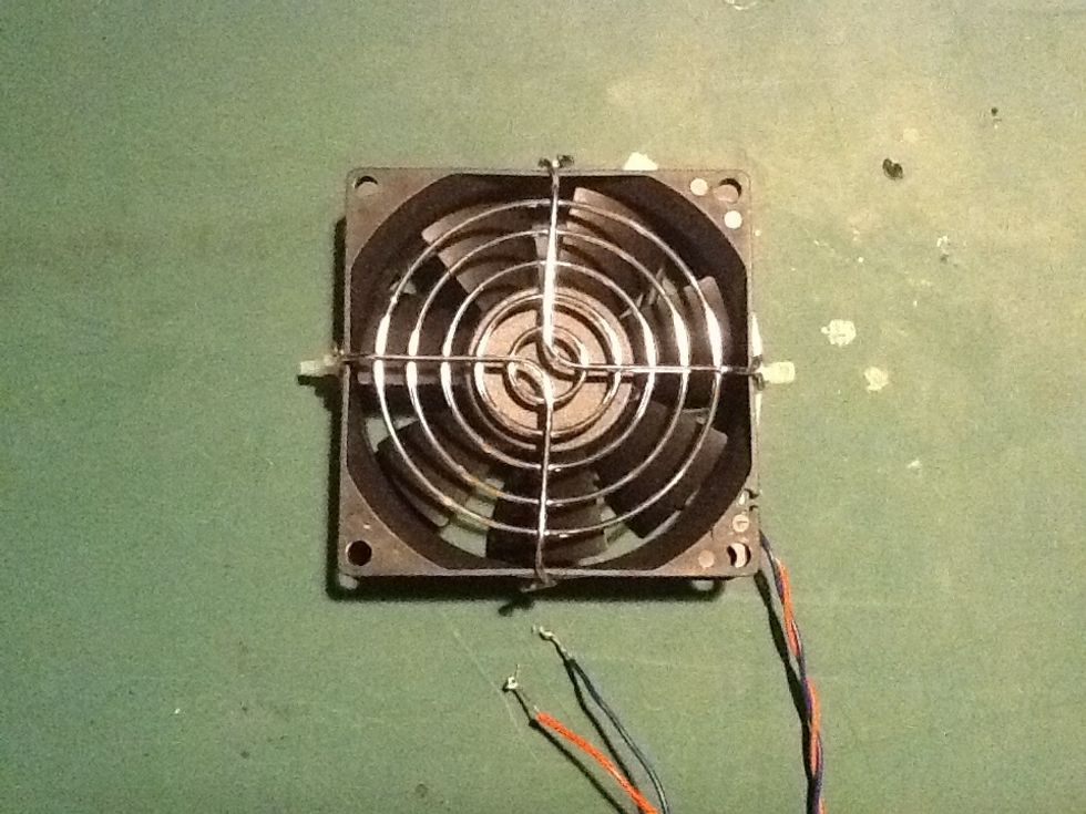Using cable ties, attach the rear fan guard to the unit. Bend the attachement points down over the fan and using a large cable tie around the circumfrance of the unit to hold the guard in place