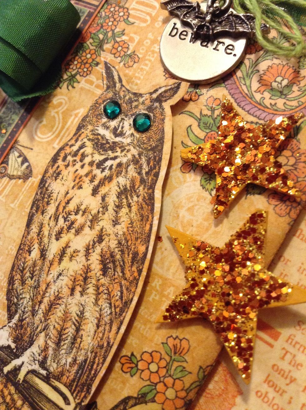 Using charms, fussy cuttings from the patterned paper, the glittered stars and the rhinestones etc. decorate your bags to your liking.