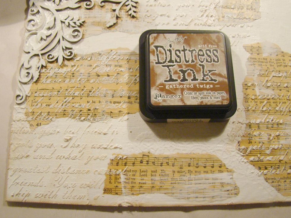 Using Distress Ink, lightly go over the high parts of your canvas for an aged look.