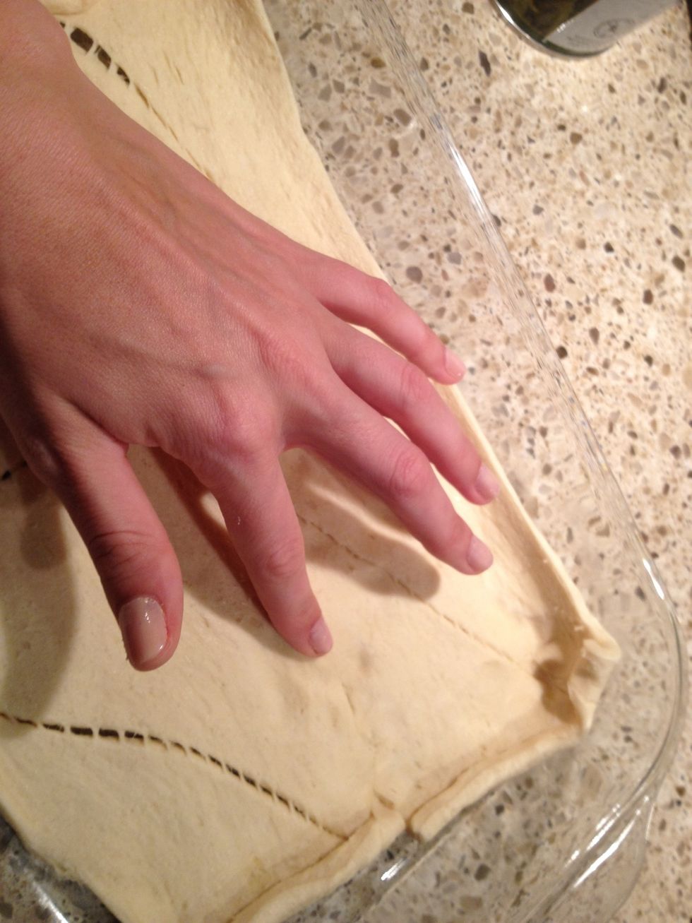 Using fingers, press together any seams to make a single sheet of dough.