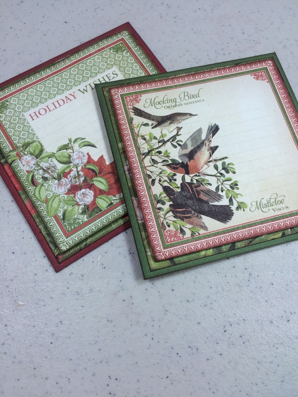 Using foam tape for dimension, adhere the 4" cut-aparts from an earlier step to the cards.