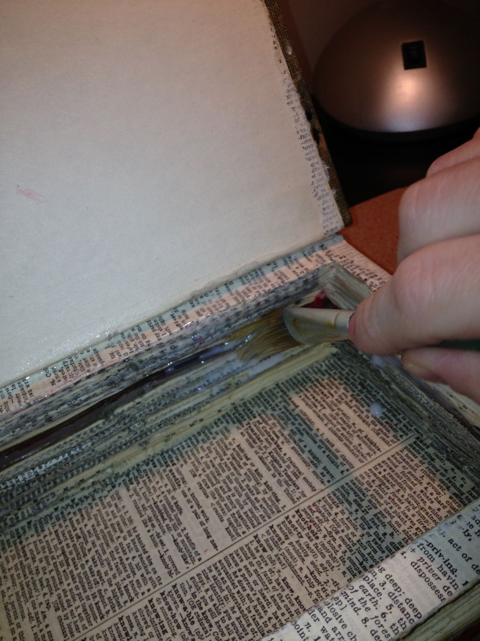 Using generous amounts, brush glue along all the sides of the book pages inside and out.