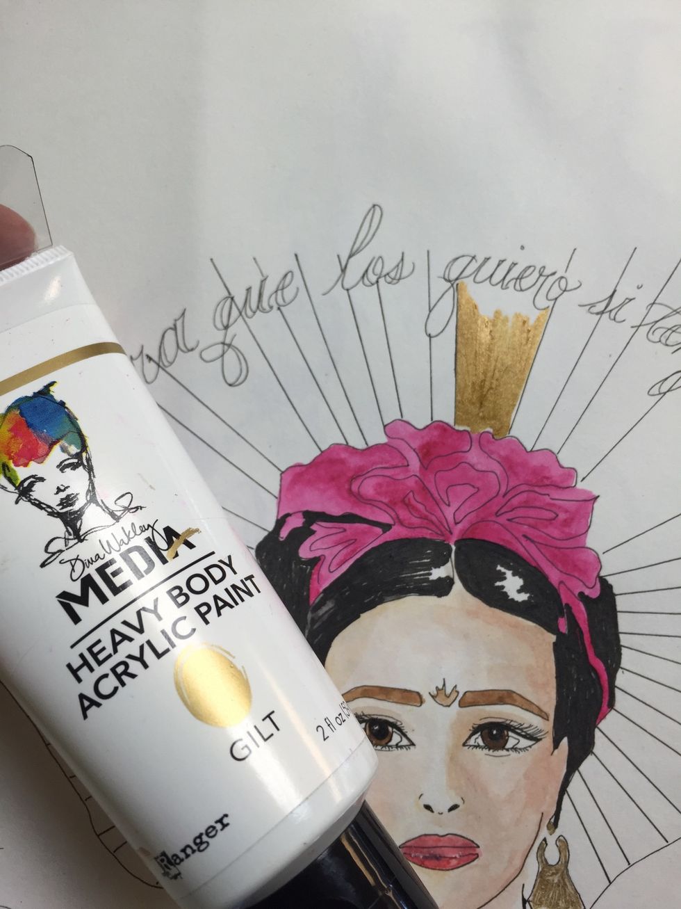 Using gilt paint the rays behind her back