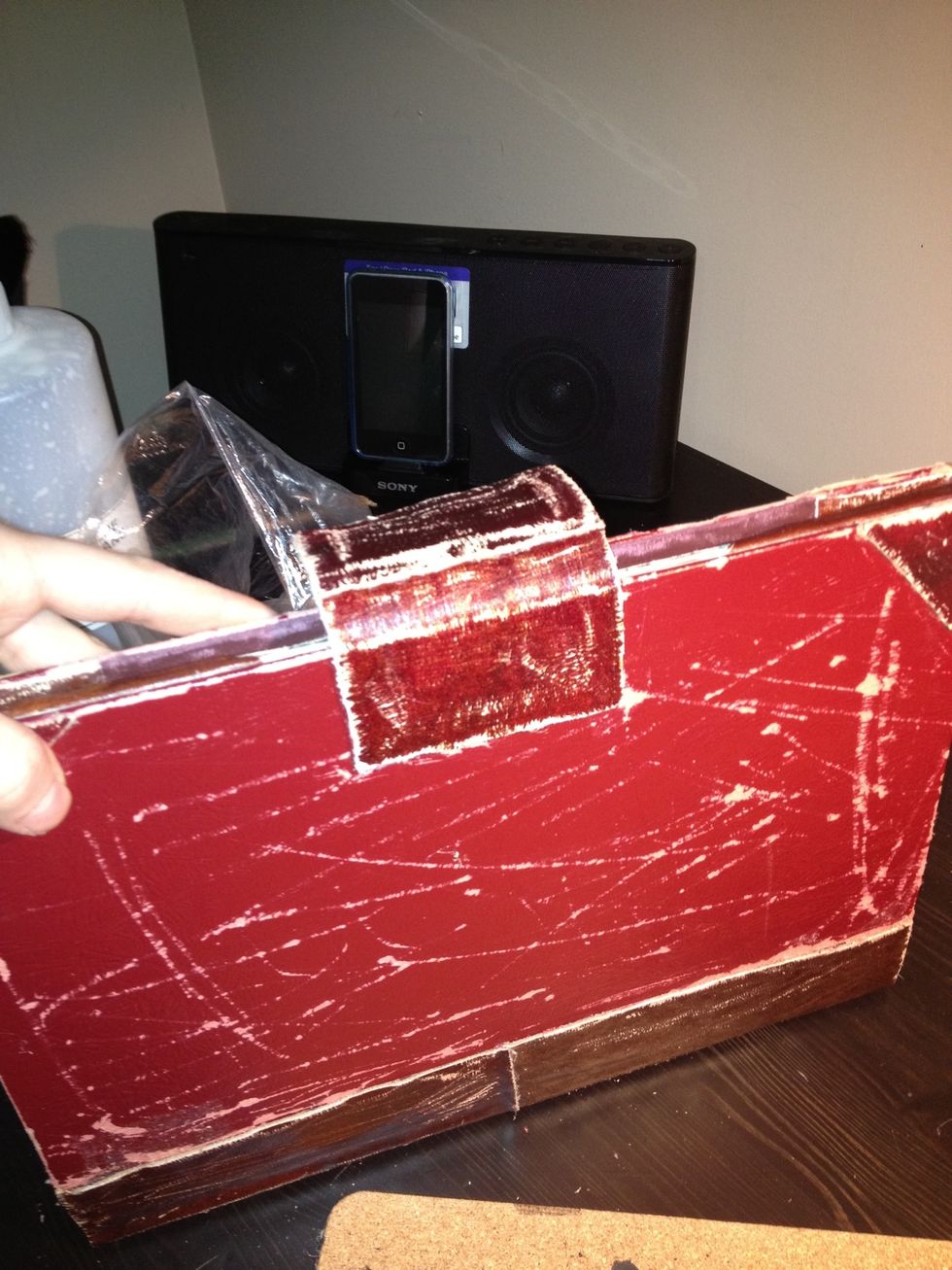 Using glue gun, glue it to the back of the case. I scraped the leather strap to give it an aged look as well.