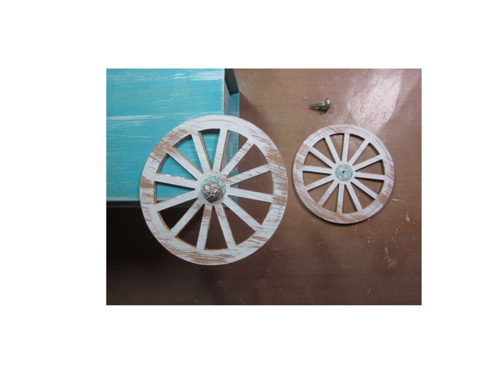 Using Graphic 45 metal brads attach the wheels to the back of the cart/box.