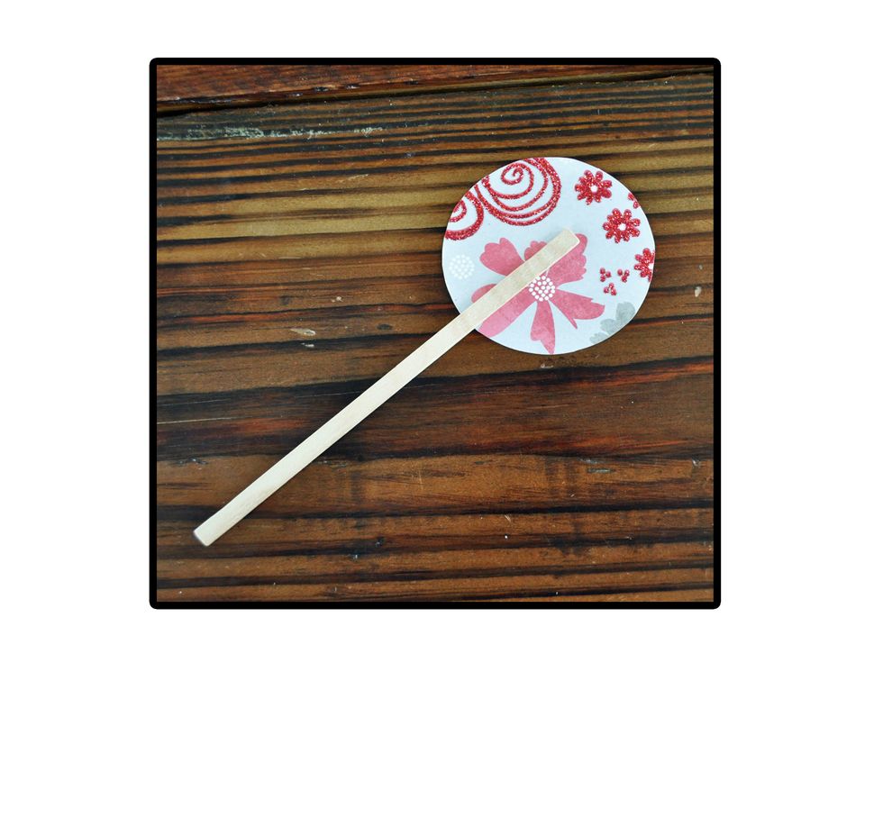 Using hot glue, adhere the craft stick to the circle. Make sure to stick it to the side you don't want showing.