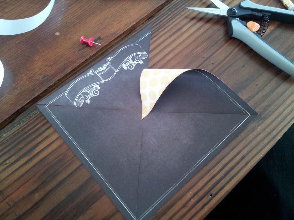 Using hot glue, fold each of the corners forward and glue one at a time. (use the same side of the sections each time so the shape comes out right).