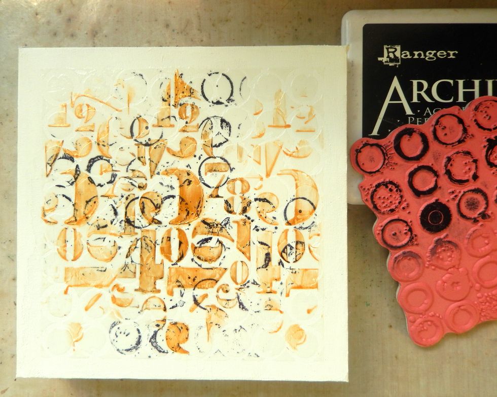 Using Jet Black Archival Ink stamp Rings across the top of random stencilled areas. Make sure you line up the rings as you go.