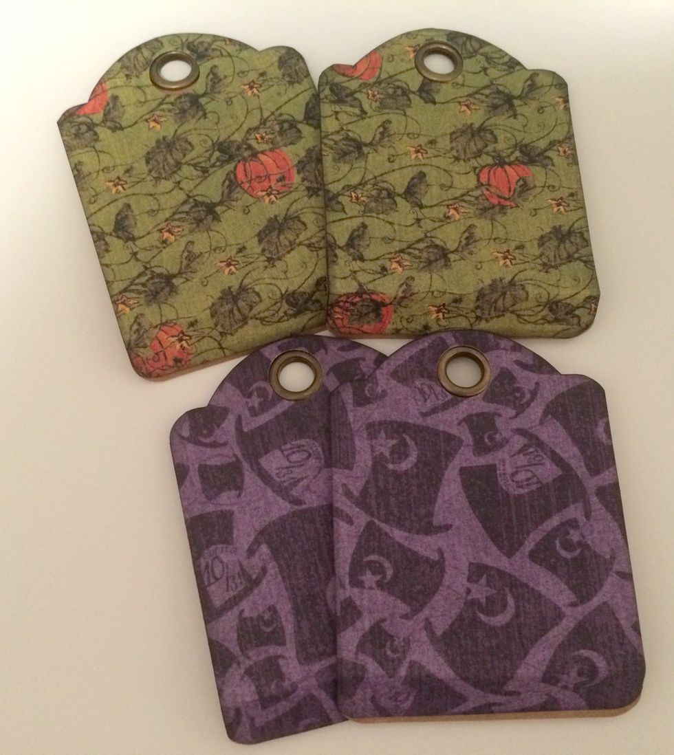 Using liquid glue, adhere the patterned paper tags, to the kraft ATC tags. Before the glue completely dries, make sure to fold the 1/2" flap up.