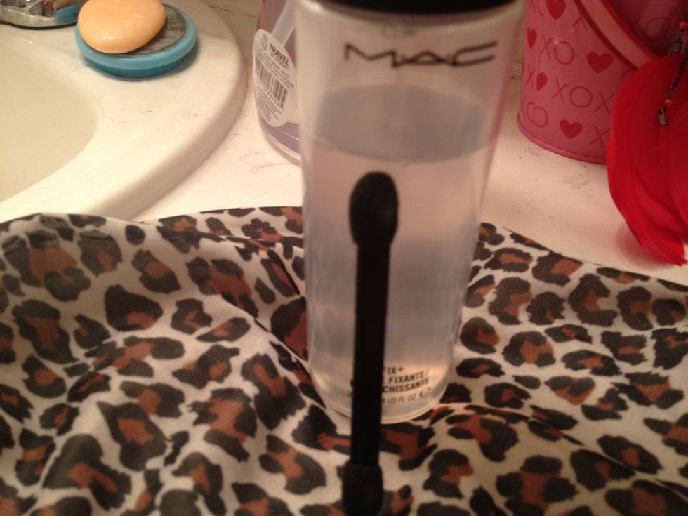Using MAC's Fix Plus, we are going to spray one end of a dual applicator sponge. This is so it is easier to pick up the next product and have a smooth look
