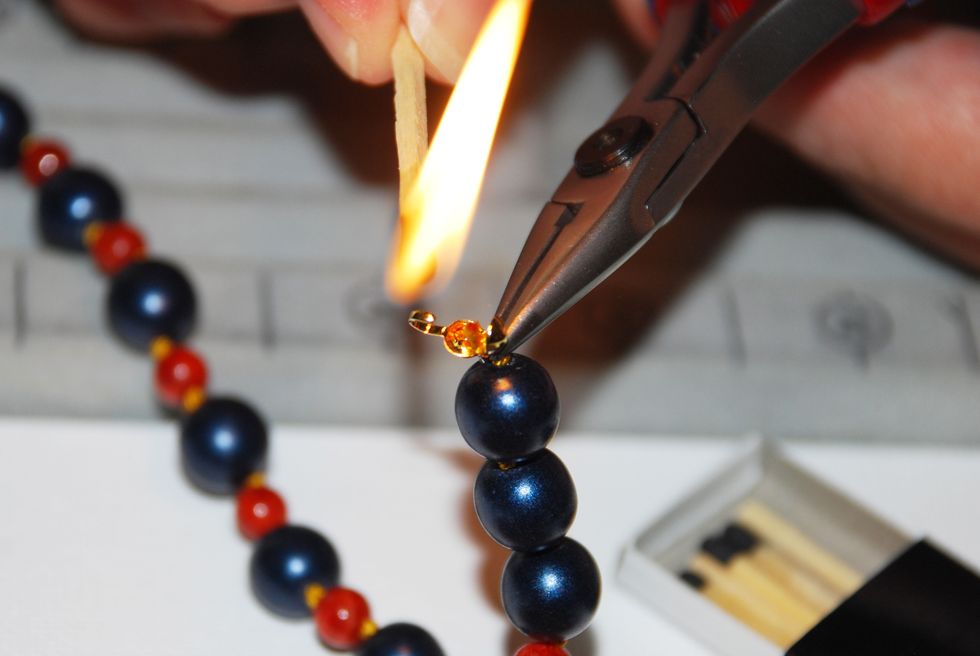 Using matches or a string zapper, gently burn/cure the end o the thread to seal it and prevent it from fraying.