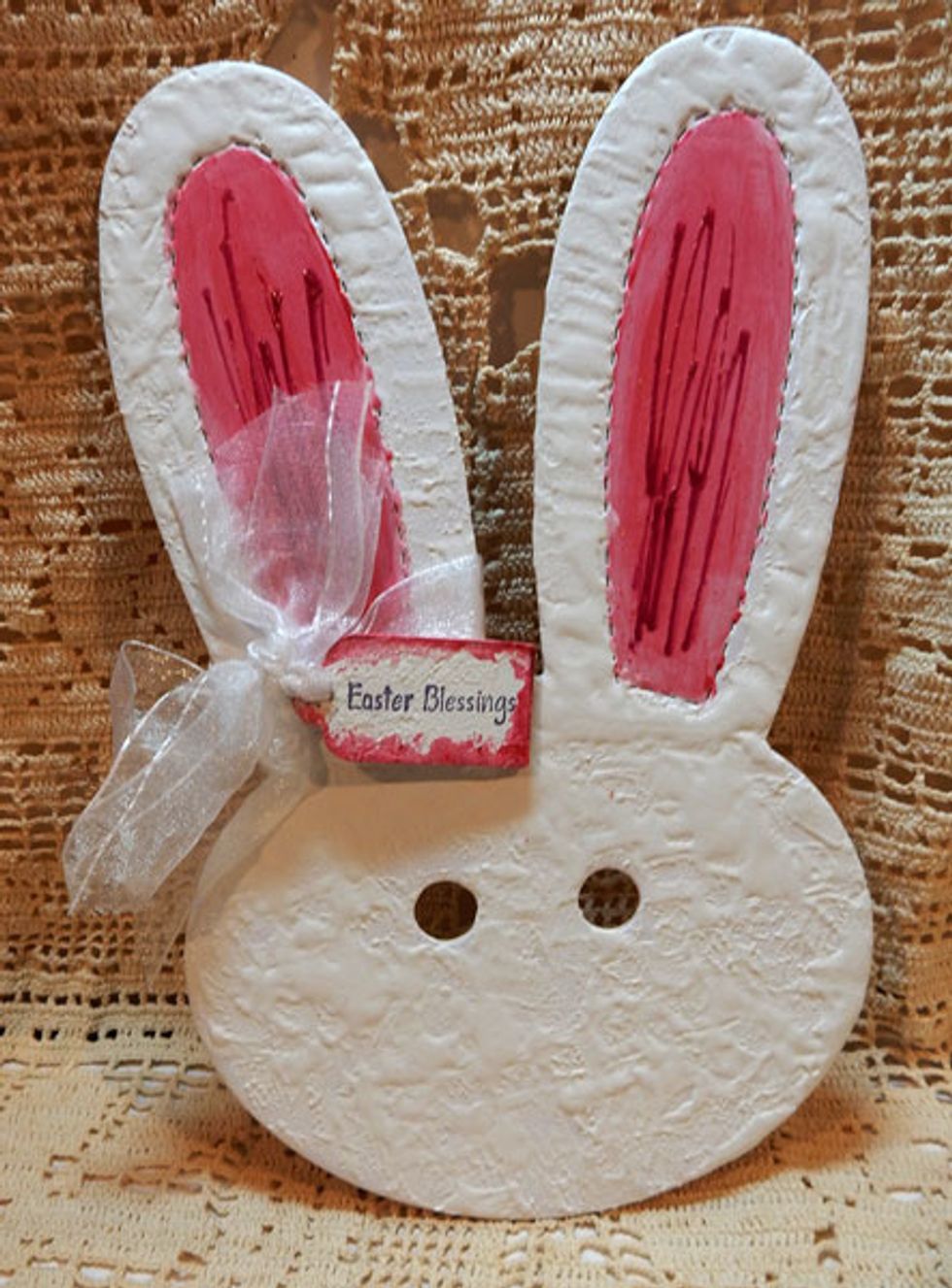 Using Mia Bella Sorbet, paint the bunny ears. Using a spackle knife, add Mud Texture Paste to the bunny. To create dimension in the ears, add streaks with Red Corvette Dimensional Crystal.
