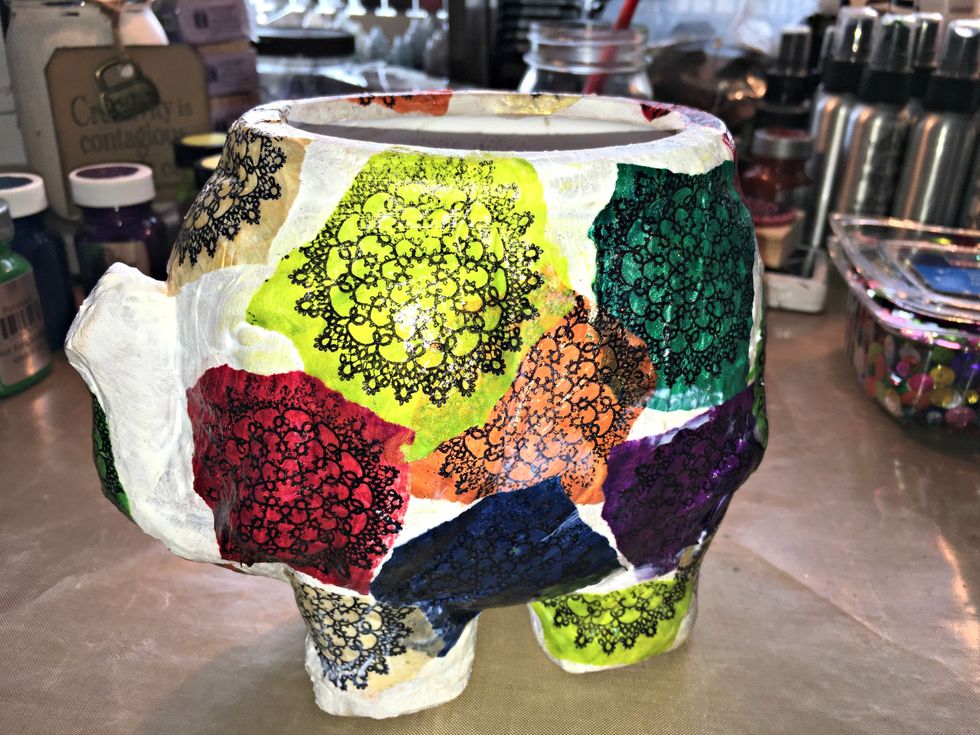 Using Mod Podge, apply your pieces all over your container. Using tissue paper with the paints provides a stain glass effect. In between the sections glue assort. sequins to fill in the gaps.