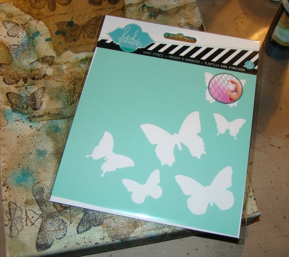 Using modeling paste and my Heidi Swapp butterfly stencil, apply butterflies randomly throughout your canvas. After stenciling I went back and added more paste to wings for dimension. Dry completely.