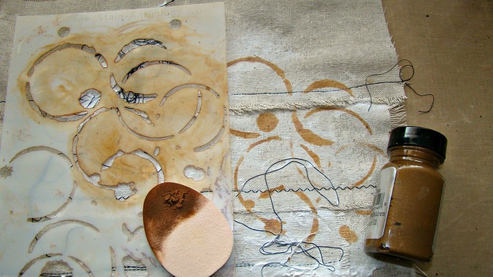 Using my coffee stain stencil I sponged on the paint to give a worn look to my backdrop.