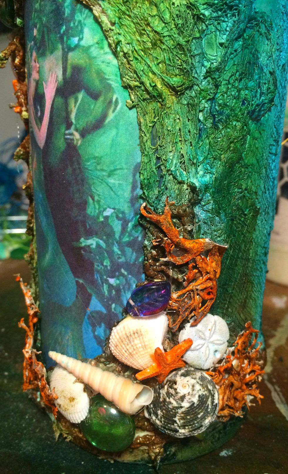 Using my hot glue gun, I started gluing on the embellishments. I just kept layering them on until I was happy with the placement.