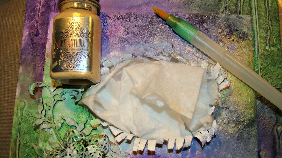 Using my Metal Effects Gold I used a water color brush and applied some to the canvas. I decided I really wanted more so I added the paint to a spray bottle with water and sprayed the canvas surface.