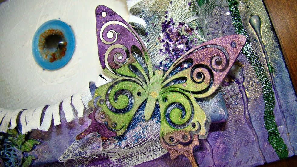 Using my sprays I then colored my butterflies and attached to the canvas.