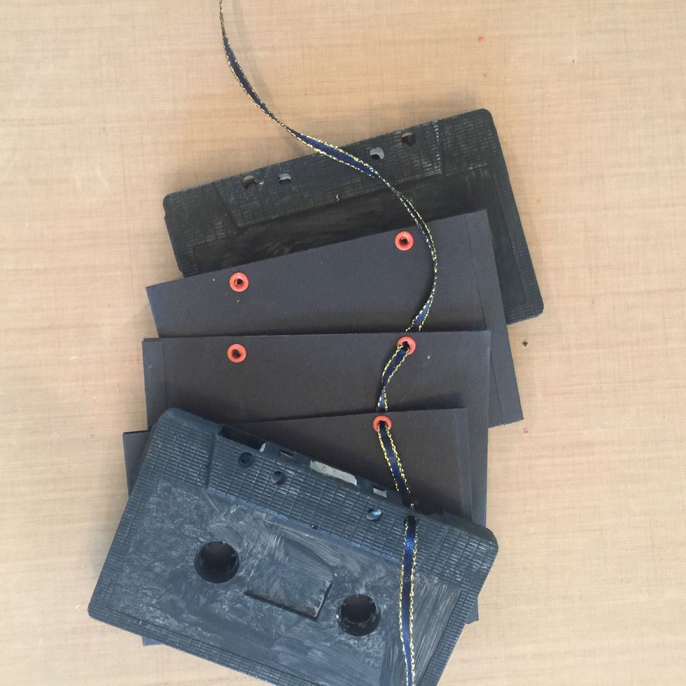 Using narrow ribbon, thread cover and pages together at top & tie off with knot and/or bow. Repeat for bottom hole. Don't tie too tight to allow for page decoration and ribbon at spine (step 11).