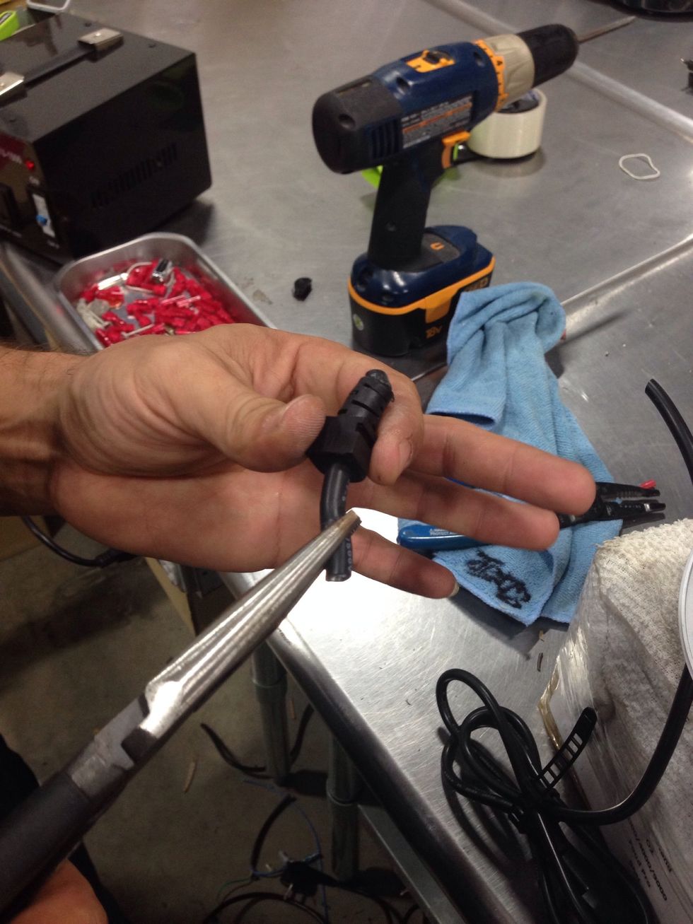 Using needle nose pliers, carefully remove the tension relief grommet