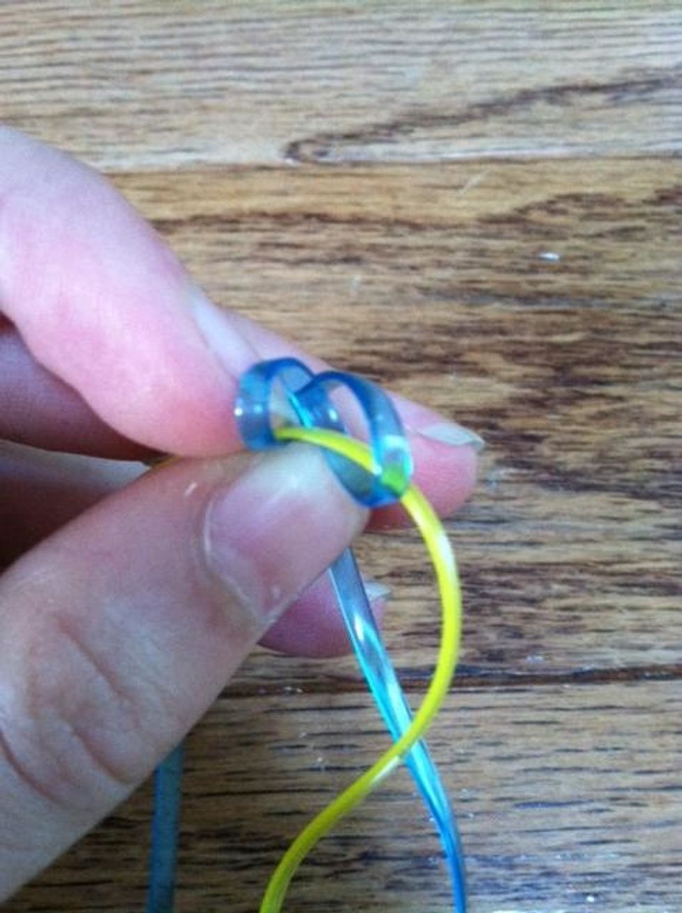Using one color (blue in example) make two loops over the other color (yellow in example)