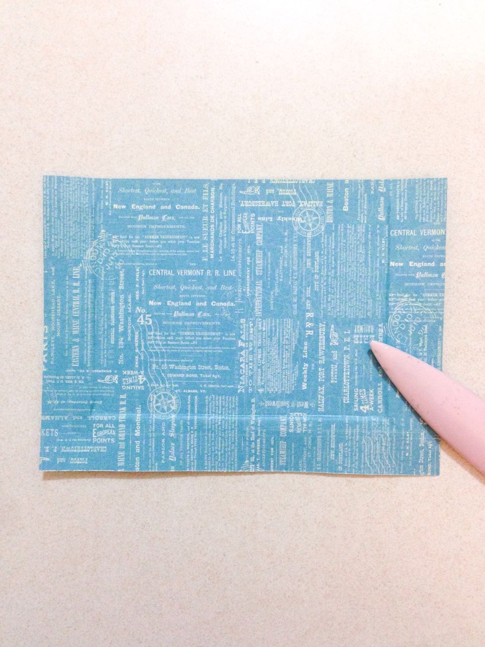 Using one of the pattern paper from the 6" x 6" Solids & Pattern paper pad, trim and glue over as shown... Use a bone folder to press down the paper around the chipboard...