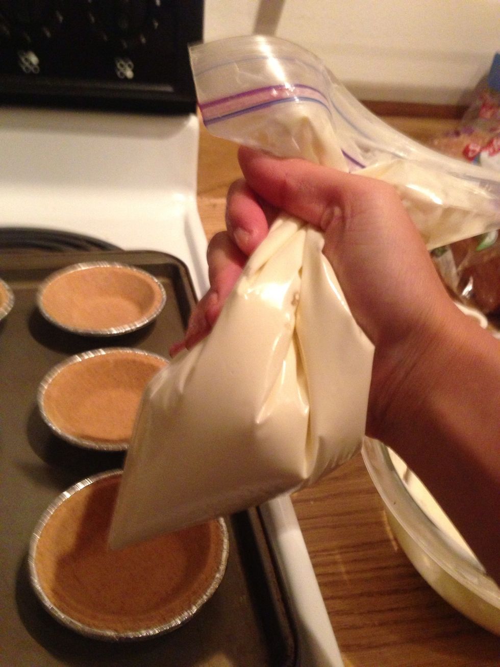 Using only half of your cream cheese mixture, fill your pie crust half way. Save what's left for our next step. (I decided to use a ziplock bag to pipe the mixture into the pie crust! Clean and easy)