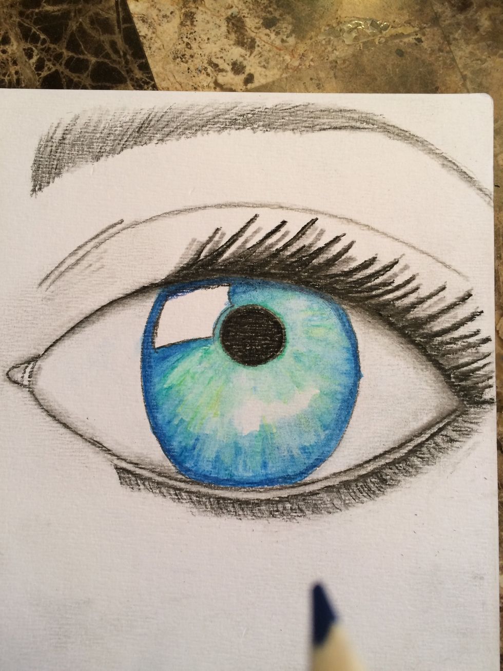 Using PITT (R) Pastel #199 (Black) and #273 (Warm Grey IV) and your blending stump outline and shade your eye, lid and eyebrow. Also fill in and shade your eyebrow.