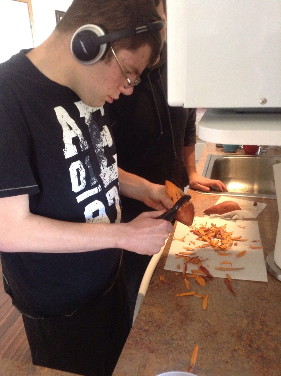 Using potato peeler carefully peel the skin off sweet potato