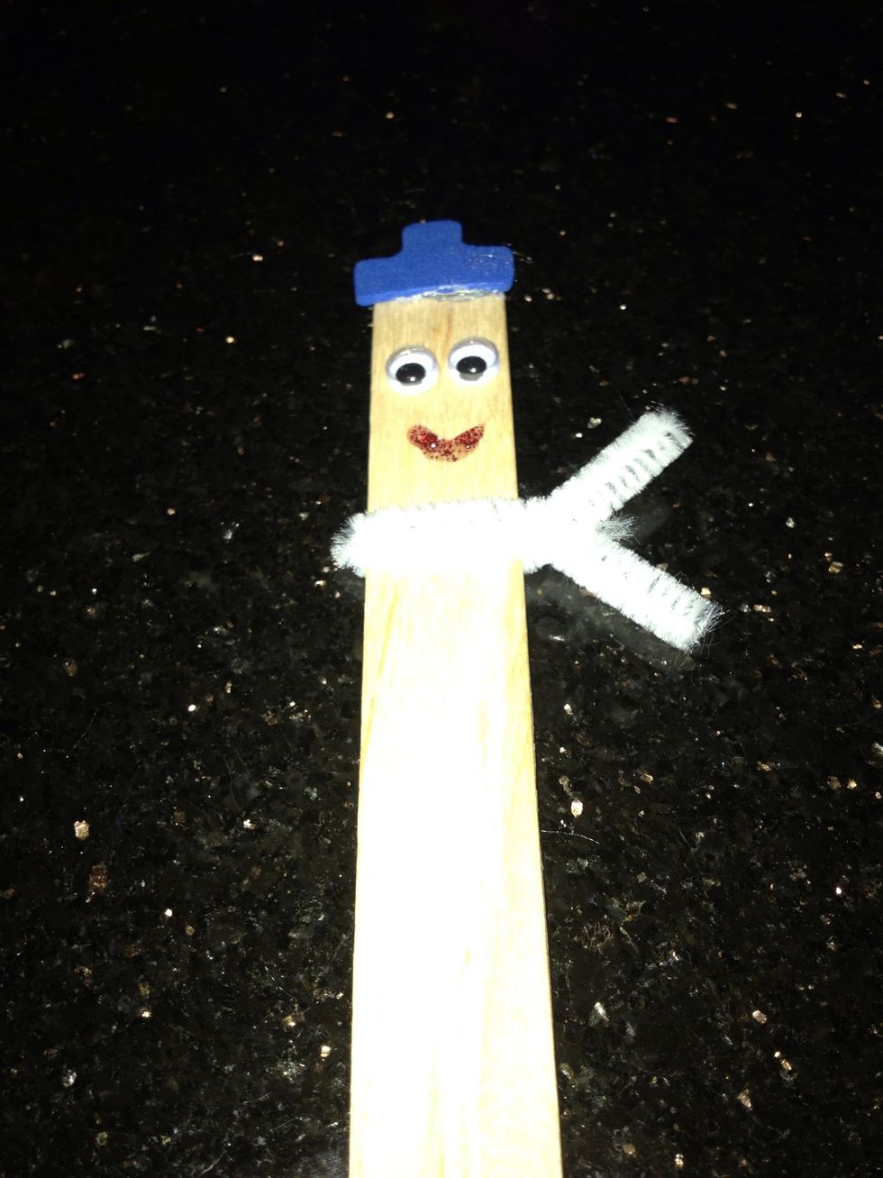 Using red glitter glue, draw on a smile.
