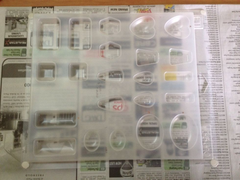 Using resin may get a little messy no matter how careful you are. Protect your work surface with newspaper taped to it. Place bluetac underneath the mould and secure it to the newspaper.