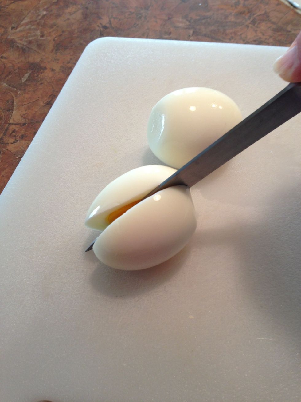 Using sharp knife, carefully slice eggs lengthwise in halves.