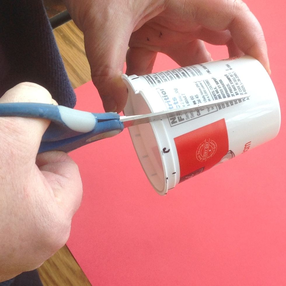 Using sharp scissors cut from each mark on the rim, AS STRAIGHT AND SMOOTHLY AS YOU CAN, down to the base of the cup.