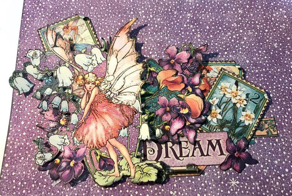 Using some of the single flowers, adhere them in amongst the fairy, other flowers and stamps.