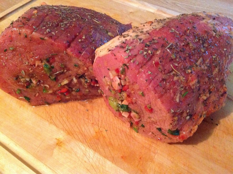 Using spoon and finger fill in holes with ingredients. I used a stuffing injector. Fill in all the way. Take remaining marinade and place all over the meat. Let sit for at least 1 hour or over night.