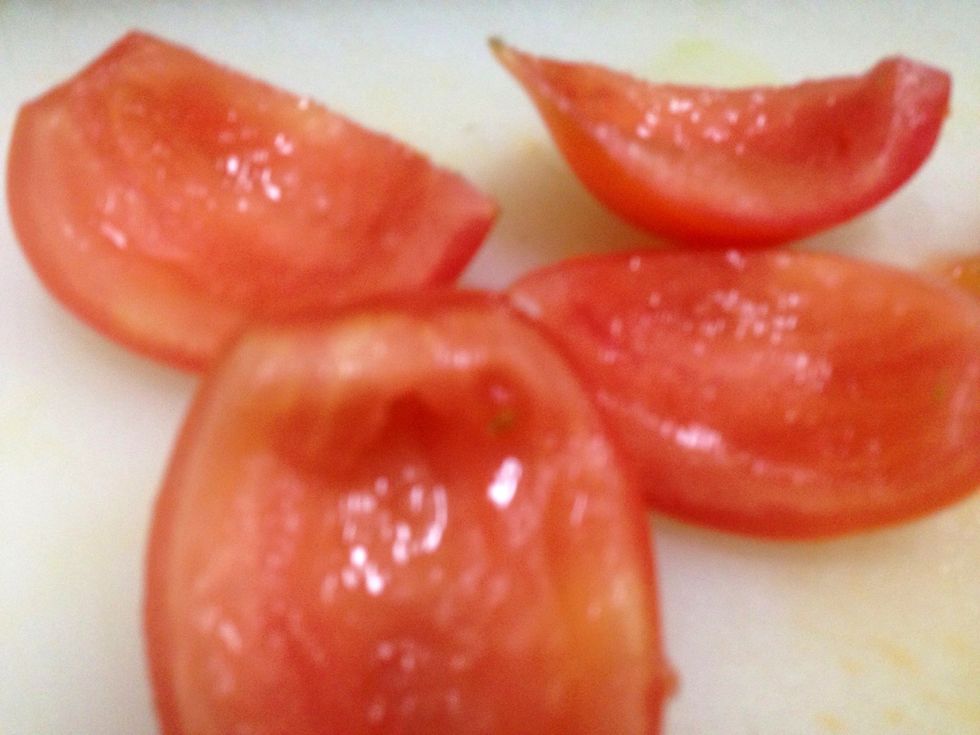 Using spoon, remove seeds of tomato