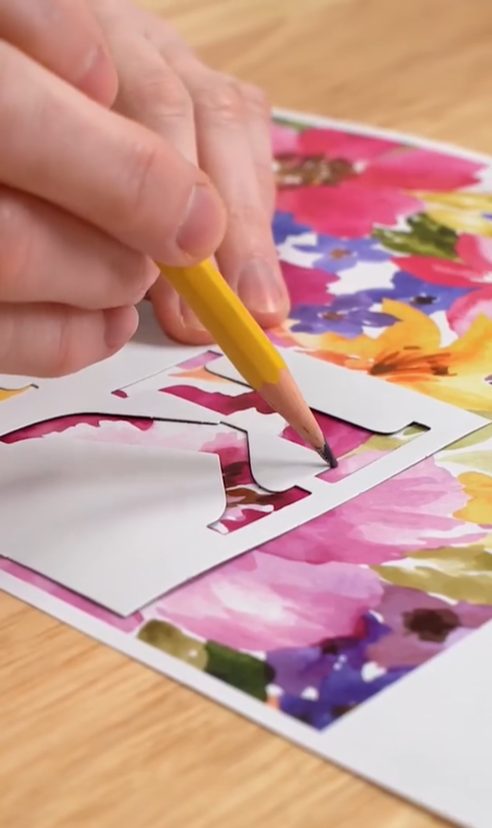 Using stencil as a pattern, trace letter onto floral paper and cut out.