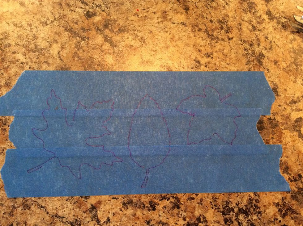 Using stencils or free form, draw your shapes (in this case leaves) out on your tape.